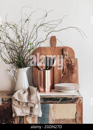 Kitchen utensils, chopping boards and plates on rustic counter Stock Photo