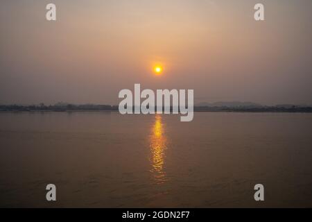 The Sunrise environment at Mekong River, shoot image from Thailand side to Laos country with sunlight reflexion on surface river. Stock Photo