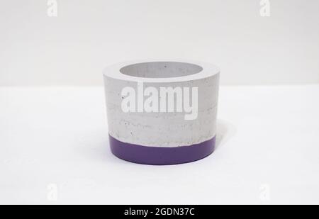 Colorful, handmade cactus pot on a white background with fine holes in the texture and painted bottom Stock Photo