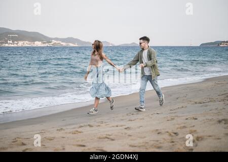 Love couple walking and holding hands. casual clothing, sunglasses. High quality photo Stock Photo