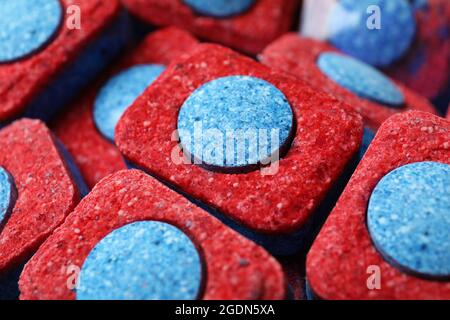 Dishwashing tablets on whole background, close up Stock Photo