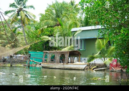 Riverside Residence and Boat on the Backwater, Cochin (Kochi) Kerala, India. © Photo by Richard Walker Stock Photo