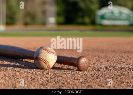 Baseball and bat low angle selective focus view on a baseball field Stock Photo