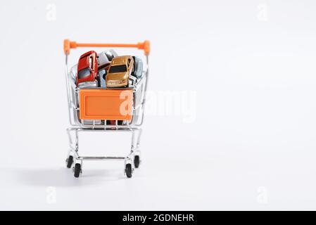Izmir, Turkey - March 08, 2021: Izmir, Turkey. Front-view colorful toy cars in the shopping cart on white background. Stock Photo