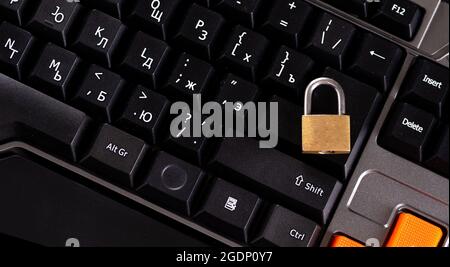 Golden padlock on laptop keyboard, information security protection, password. Stock Photo
