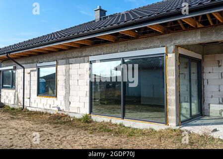 Newly installed not opened window with roller shutters in the house under construction. Stock Photo