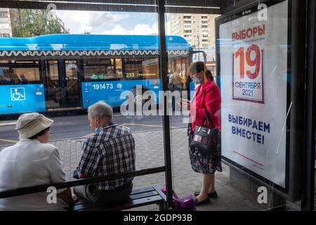 Moscow, Russia. 14th of August, 2021 A banner informing about the voting on September 19 for deputies to the State Duma of the Russian Federation at a bus stop in Moscow, Russia. The banner reads '19 september. We choose together' Stock Photo