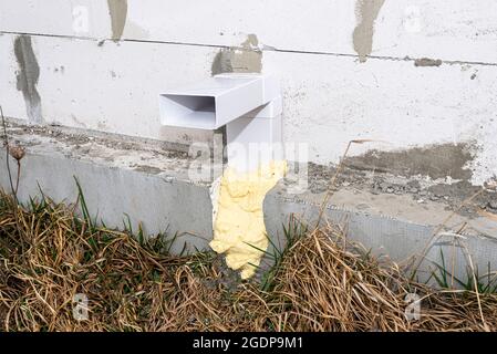 Air intake from the manor to the fireplace with a closed combustion chamber, a plastic pipe in the wall of the building. Stock Photo