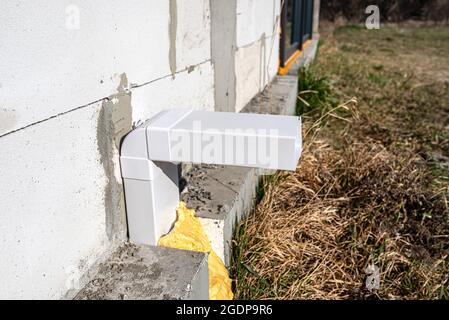 Air intake from the manor to the fireplace with a closed combustion chamber, a plastic pipe in the wall of the building. Stock Photo