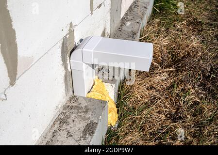 Air intake from the manor to the fireplace with a closed combustion chamber, a plastic pipe in the wall of the building. Stock Photo