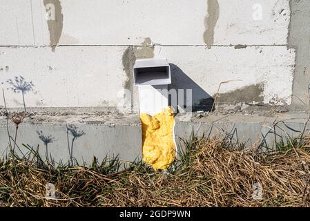 Air intake from the manor to the fireplace with a closed combustion chamber, a plastic pipe in the wall of the building. Stock Photo