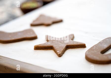 Holiday Cutout Cookies on Parchment Paper and Baking Sheet Stock Photo