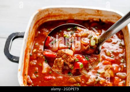 Goulash soup in big saucepan. Dinner time Stock Photo