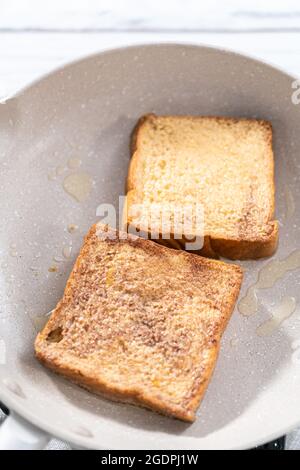 Frying french toast in a nonstick frying pan. Stock Photo