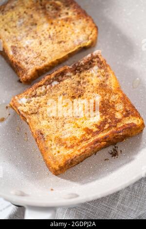 Frying french toast in a nonstick frying pan. Stock Photo