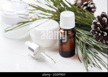 Beauty products, essential oil, and cosmetics with Christmas decoration on shabby white wooden background Stock Photo