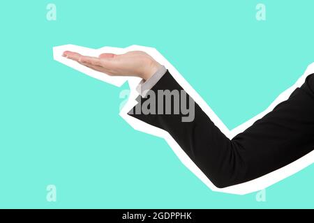 Hand of business woman holding copy space. Magazine style isolated on pink background Stock Photo