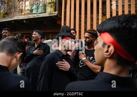 Srinagar, India. 14th Aug, 2021. Kashmiri Shia Muslims beat their chests as they mourn during a muharram procession in Srinagar. Muharram is the first month of Islam. It is one of the holiest months in the Islamic calendar. Shia Muslims commemorate Muharram as a month of mourning in remembrance of the Martyrdom Islamic Prophet Muhammad's grandson Imam Hussain, who was killed on Ashura (10th day of Muharram) in the battle of Karbala in 680 A.D. (Photo by Idrees Abbas/SOPA Images/Sipa USA) Credit: Sipa USA/Alamy Live News Stock Photo
