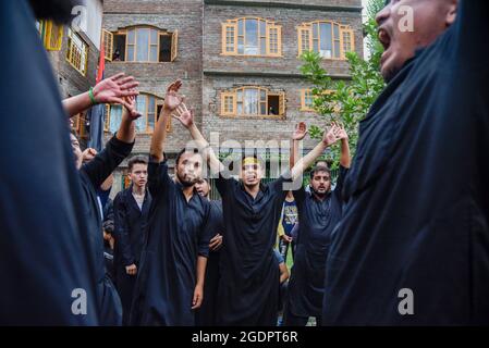 Kashmiri Shia Muslims shout religious slogans after erecting a tall ...