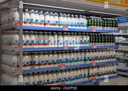 Moscow, Russia- June 6. 2021. Milk in a plastic bottles on the counter in Auchan store Stock Photo