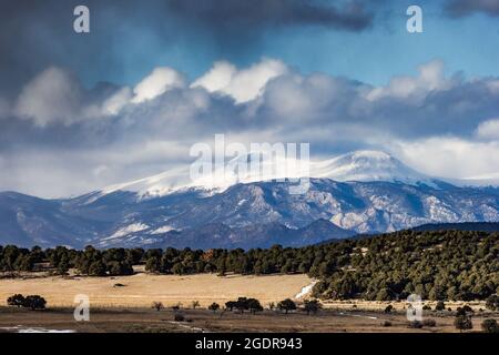 a winter snowstorm rolls over the Buffalo Peaks in the central Colorado Rockies as seen from the foothills of the Sangre de Christo Range Stock Photo