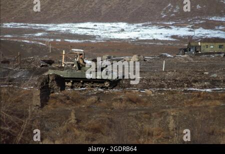 Circa 1980's, Afghanistan: A Soviet armored vehicle fighting against the Mujahideen in the rugged, inhospitable terrain of Afghanistan. Insurgent groups in Afghanistan (known collectively as the mujahideen) fought a nine-year guerrilla war against the Soviet Army and the Democratic Republic of Afghanistan government throughout the 1980s, mostly in the Afghan countryside. In what was a Cold War-era proxy war, the Mujahideen were backed by the United States, Pakistan, Iran, Saudi Arabia, China, and the United Kingdom. (Credit Image: © Mark Richards/ZUMA Press Wire Service) Stock Photo