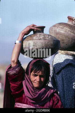 Circa 1980's, Afghanistan: Refugees in camps along the Pakistan-Afghanistan border. Insurgent groups in Afghanistan (known collectively as the mujahideen) fought a nine-year guerrilla war against the Soviet Army and the Democratic Republic of Afghanistan government throughout the 1980s, mostly in the Afghan countryside. In what was a Cold War-era proxy war, the Mujahideen were backed by the United States, Pakistan, Iran, Saudi Arabia, China, and the United Kingdom. (Credit Image: © Mark Richards/ZUMA Press Wire Service) Stock Photo