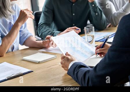 Closeup male hands making notes in financial report at table meeting. Stock Photo