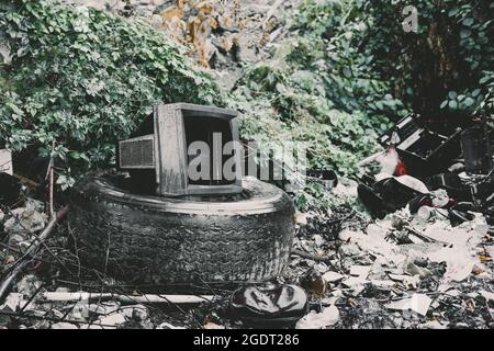 Old broken TV at garbage . Ecology concept Stock Photo