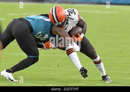 Jacksonville Jaguars running back D'Ernest Johnson (25) is tackled by Detroit  Lions linebacker Julian Okwara (99) defensive tackle Cory Durden (90) and  linebacker Jalen Reeves-Maybin (42) against the Detroit Lions during an