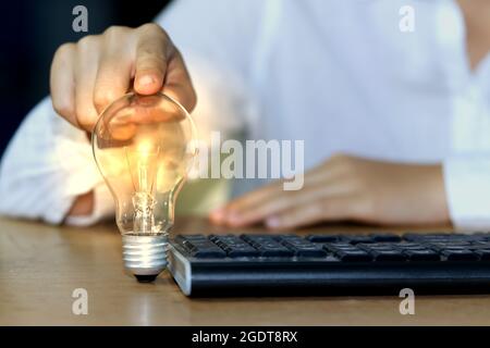 Concept ideas and light bulbs with connecting wires. Business people show new ideas by using innovative technology and creativity. Stock Photo