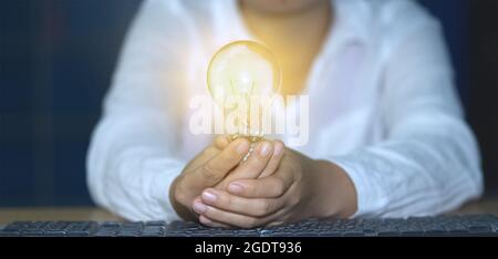 Concept ideas and light bulbs with connecting wires. Business people show new ideas by using innovative technology and creativity. Stock Photo