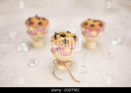 Fresh homemade banana muffins decorated with chocolate chips on the table Stock Photo