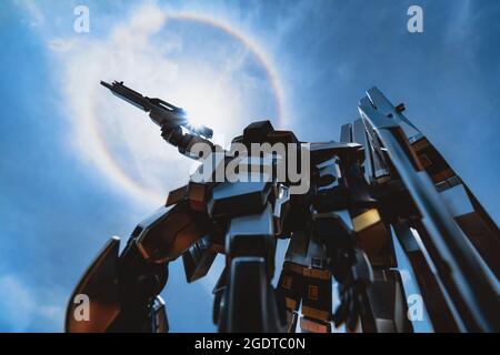 Bangkok, Thailand - August 14, 2021 : Plastic figurine of Nu Gundam RX-93 from One Gundam animation with fantastic sun halo. Editorial use only Stock Photo