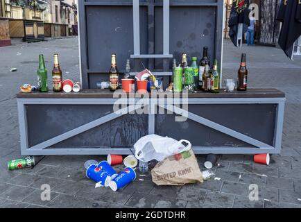 MINSK - JUL 30: Morning. Garbage at the night club after party. Bottles, cans, paper packages and boxes in a street. July 30. 2021 in Minsk, Belarus Stock Photo