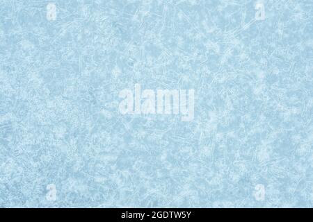 Icy light blue background with a beautiful frozen textured pattern with white luminous patches of the pattern. Stock Photo