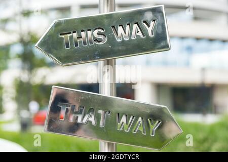 silvery arrow signs pointing in opposite directions Stock Photo