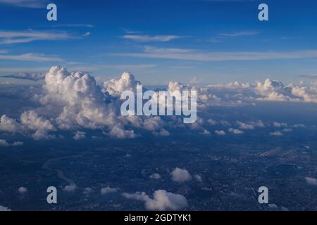 cityscape view from airplane with cloudy blue sky above, photo may has some noise Stock Photo