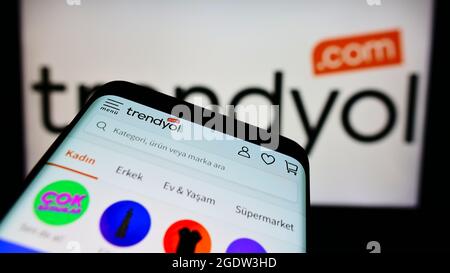 Mobile phone with website of Turkish e-commerce company Trendyol on screen in front of business logo. Focus on top-left of phone display. Stock Photo