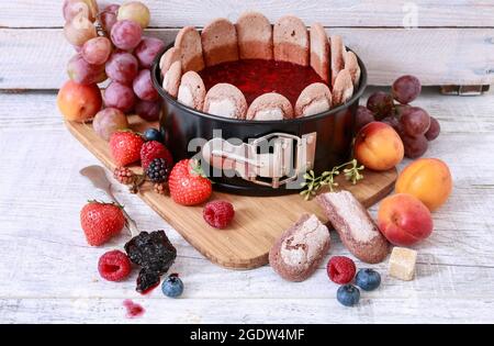 Diplomat Cake or Charlotte Cake with Strwaberries and Lady Fingers in Baking  Pan on a Wooden Table with Yellow Background / Focus Stock Image - Image of  food, background: 138065587