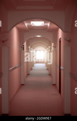 The long corridor in the hotel is red. Stock Photo