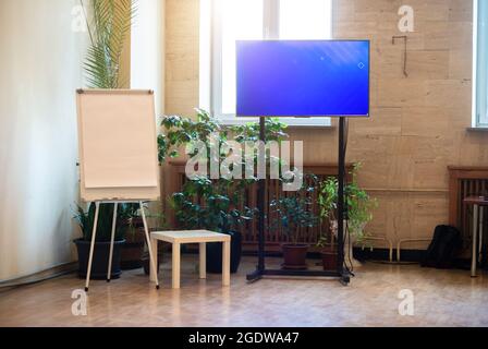 Whiteboard for business presentations and a large flat TV. Stock Photo