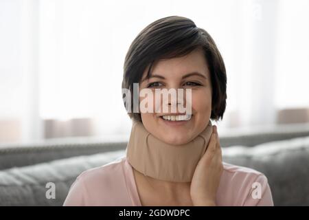 Woman wearing cervical supportive collar, orthopedic brace for spinal muscles Stock Photo