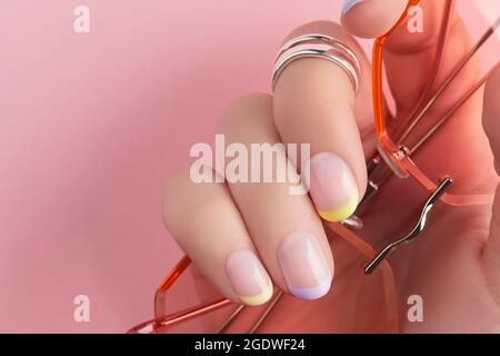 Close up manicured womans hands on pink background Stock Photo