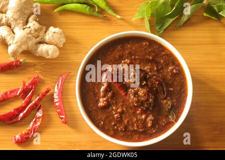 Ginger curry is a dark brown sweet-sour and spicy Keralite curry made of ginger, tamarind, green chillies and jaggery. It is also known as Injipuli or Stock Photo