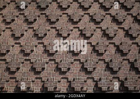 View on red old church brick wall with repetitive greek ordinary cross pattern with equal limbs Stock Photo