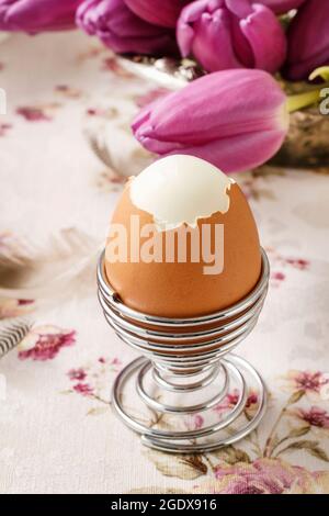 Easter egg and violet tulips on the table. Party time Stock Photo