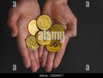 Man hands holding Bitcoin BTC crypto currency gold coins, new virtual money concept. Mining or blockchain technology Stock Photo