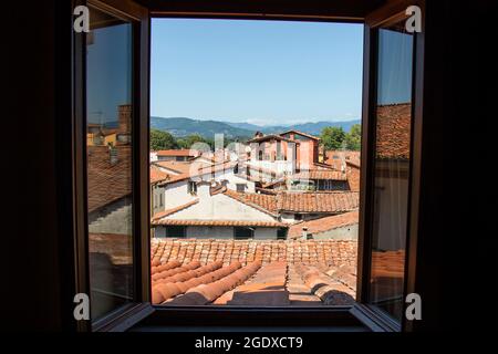 view from an open window on the roof of houses in the old town in Lucca, Italy Stock Photo