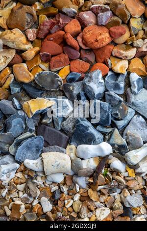 Pebbles and stones from a beach sorted into colours Stock Photo
